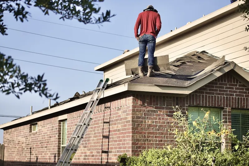 Professional roofer working on a residential roof in Riegel Ridge